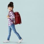 Young asian kid student with a backpack portrait